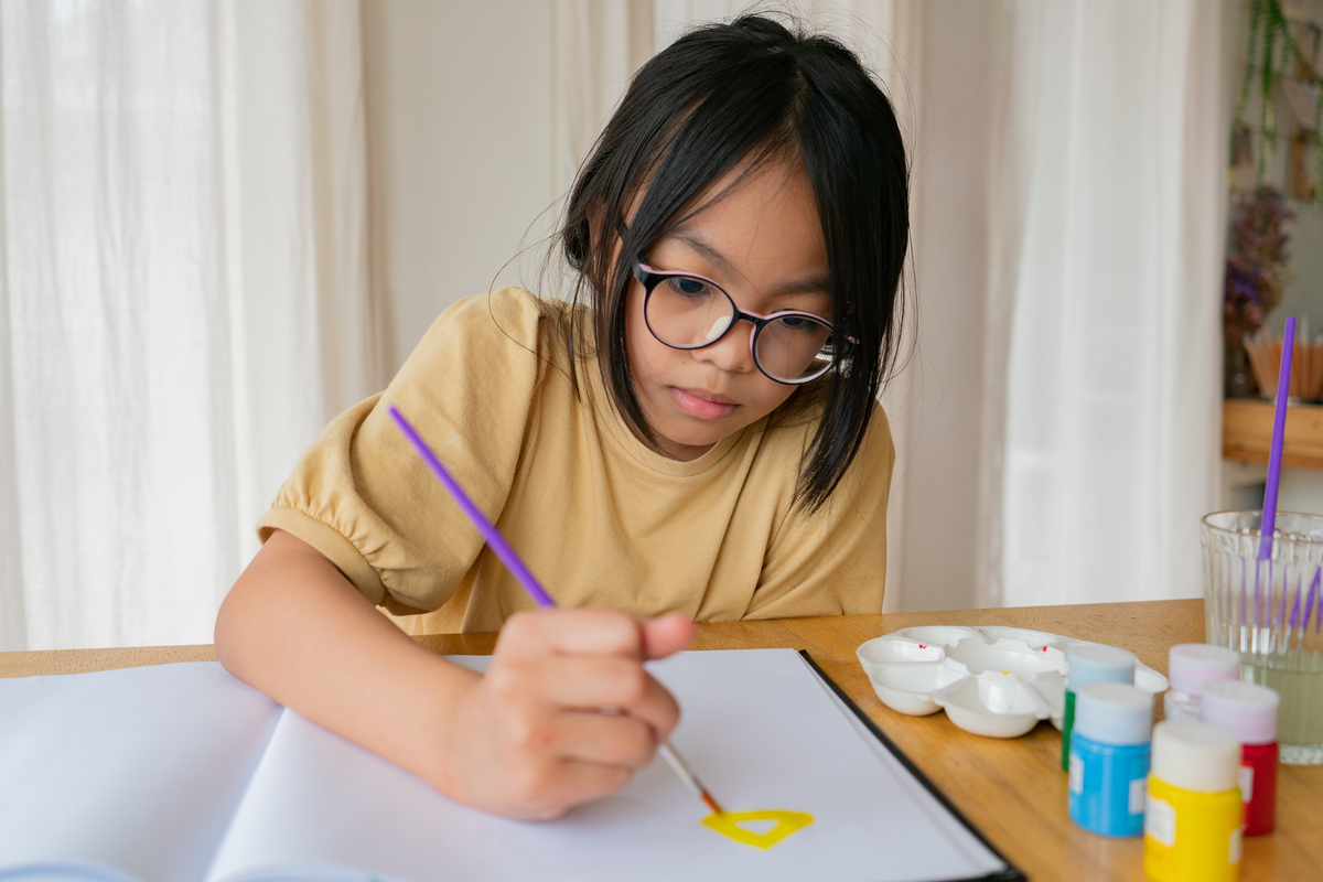 Young asian girl painting