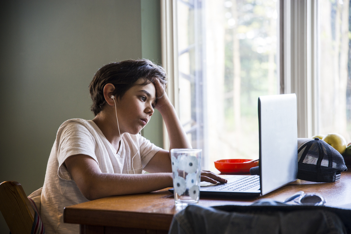 Young boy using a laptop at home