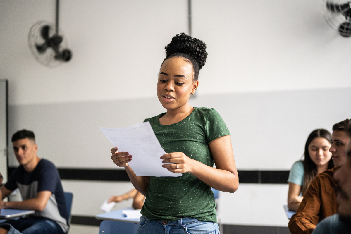 Teenage student reading aloud in class