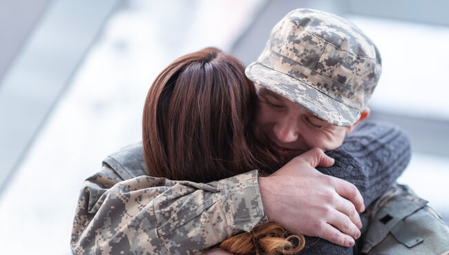 Veteran hugging his wife